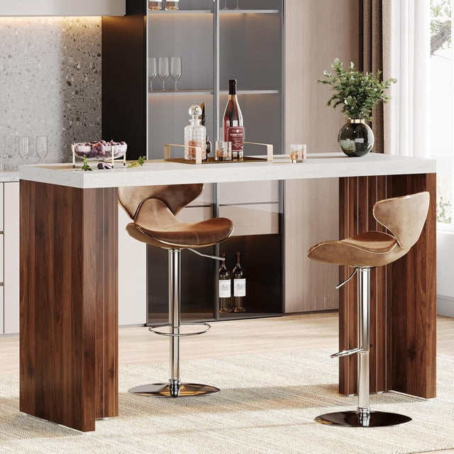Tribesigns Home Bar Unit, a 55.12-inch bar table with a faux marble finished tabletop and walnut-finish legs. Displayed in a contemporary home setting with two bar stools, it is styled with wine bottles, glasses, and decor. Measuring 55.12 inches wide, 19.69 inches deep, and 36.02 inches high, it is ideal for kitchens, living rooms, or basements. The 1.57-inch thick tabletop and sturdy frame ensure stability and durability.