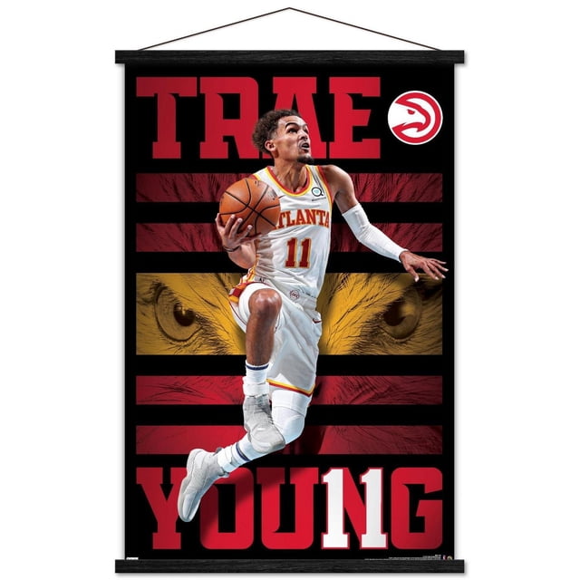 NBA Atlanta Hawks - Trae Young 20 Wall Poster, 22.375" x 34" Framed showing a basketball player in white Atlanta Hawks jersey number 11 mid-air holding a basketball, set against a black background with red and gold stripes and hawk eyes graphic, with large red text 'TRAE' at the top and 'YOUNG' at the bottom, plus the Atlanta Hawks logo in the upper right corner, ideal for sports fan room decor.