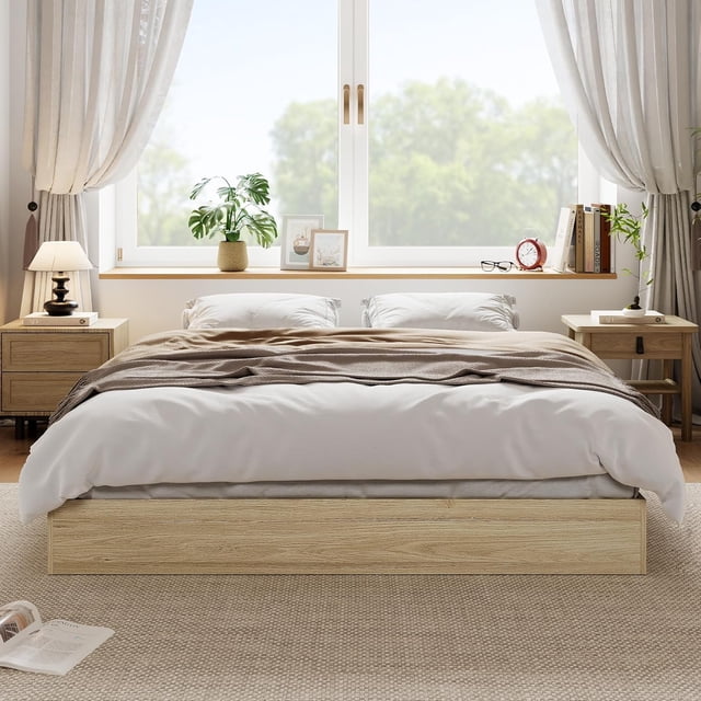 EDTara Solid Wood Platform Bed with Sturdy Wooden Slats, Full Size Floor-Standing Bed Frame. The bed features a low-profile, minimalist design with a natural wood grain finish, blending seamlessly with modern or Scandinavian decor. It is shown in a bright bedroom setting with neutral tones, positioned against a large window. The sturdy wooden slats provide robust support without the need for a box spring, and the headboard-free design allows versatile placement. Ideal for small or modern spaces, this bed frame is easy to assemble and maintain.