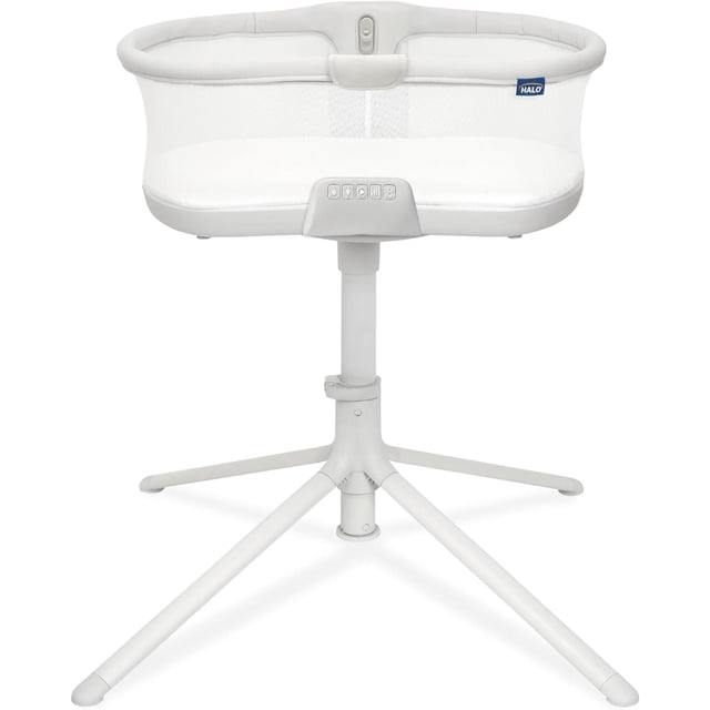 HALO BassiNest Soothing Swivel Sleeper 3.0 in grey, a portable baby bassinet with mesh sides and an oval sleeping area on a height-adjustable white metal base with four legs, featuring built-in vibration and white noise controls for safe sleep.