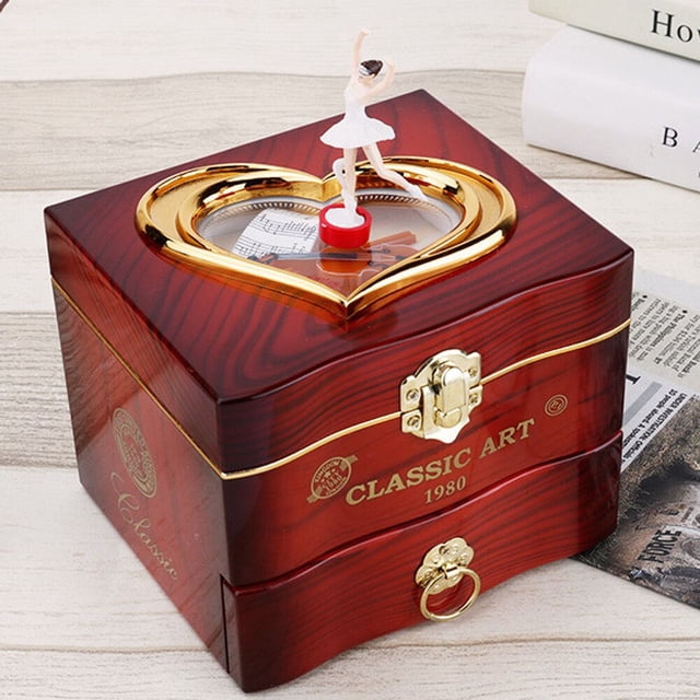Dancing Ballerina Music Box Plastic Jewellery Box featuring a red ABS material with a glossy wood-like finish. The box has a heart-shaped golden frame on the lid, showcasing a white ballerina figurine on a red base. The front includes a gold latch and decorative accents, with 'Classic Art 1980' text. Suitable for jewellery storage, home decoration, or as a gift. Dimensions: 13.5cm x 12.0cm x 11.0cm (5.31 x 4.72 x 4.33 inches).
