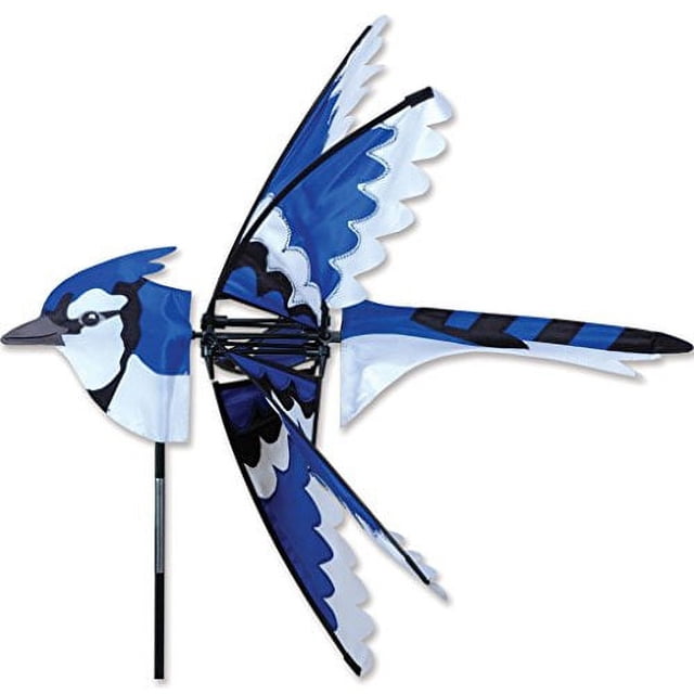 Premier Kites 25 in. Eastern Blue Jay Spinner featuring a vibrant blue and white design resembling a blue jay in flight. Made from 100% UV-resistant fabric, it includes a support pole and ground stake for easy assembly. Measures 25.5 x 26 inches with a 26-inch diameter, ideal for yard decoration or outdoor play.
