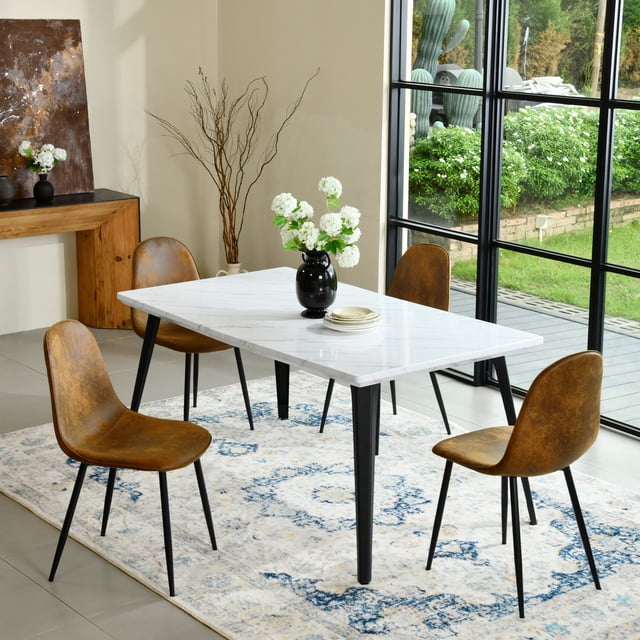 Homy Casa 63 inch Modern Dining Set with a rectangular faux marble tabletop and black metal legs, paired with four brown fabric upholstered chairs with black legs, arranged on a blue and beige patterned rug near large black-framed windows overlooking a garden, ideal for kitchen or dining room spaces.