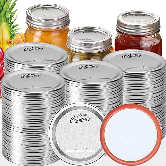 Canning Lids 100 PCS, 70MM 86MM split-type canning lids arranged in stacks. These rust-proof tinplate lids have a smooth silver finish and BPA-free silicone sealing rings for airtight and leak-proof food storage. Behind the lids, jars filled with preserved fruits and vegetables highlight their use for canning and food preservation.