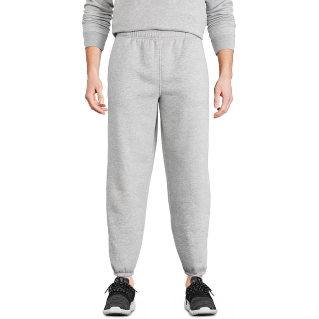 Athletic Works Men's Fleece Pant in light grey with elasticized waistband and cuffs, featuring a relaxed fit and two on-seam pockets, shown front-facing on a model wearing black sneakers and a grey sweatshirt, suitable for casual wear, lounging, or quick errands.