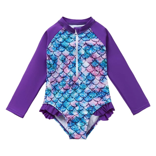 PMVFHDE Toddler Girls' Summer One-Piece Beach Swimwear featuring a fish scale print in vibrant blue, pink, and purple tones. This long-sleeve rash guard has a front zipper for easy wear and is made of breathable polyester with UPF 50+ sun protection. The swimsuit includes purple sleeves and ruffle accents at the leg openings, designed for toddlers aged 3-4 years.