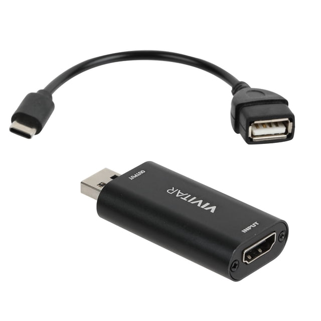 HDMI to USB Video Capture Card by Vivitar with a black USB-C to USB-A adapter cable, featuring a compact matte black rectangular device with HDMI input and USB output ports, designed for low latency Full HD 1080p video and audio streaming to laptops, desktops, and smartphones.