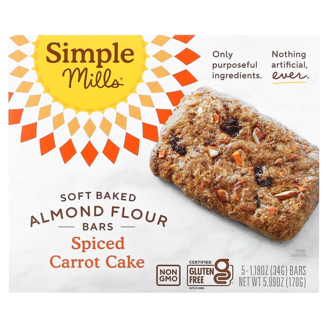 Simple Mills Soft-Baked Almond Flour Bars in Spiced Carrot Cake flavor, featuring a box of 5 individually wrapped bars, each weighing 1.19 oz (34 g). The packaging highlights key features such as being certified gluten-free, non-GMO, and made with whole food ingredients like almonds, honey, chia, flax, and sunflower seeds. The front of the box displays a close-up of a spiced carrot cake bar with visible ingredients like raisins and carrot pieces.