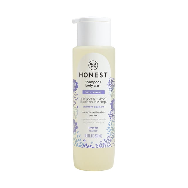 The Honest Company Shampoo & Body Wash (18 oz) - Truly Calming Lavender in a translucent beige bottle with a white pump dispenser, featuring purple and blue floral designs and bilingual English-French text, formulated with tear-free, naturally derived ingredients for gentle cleansing of sensitive skin.