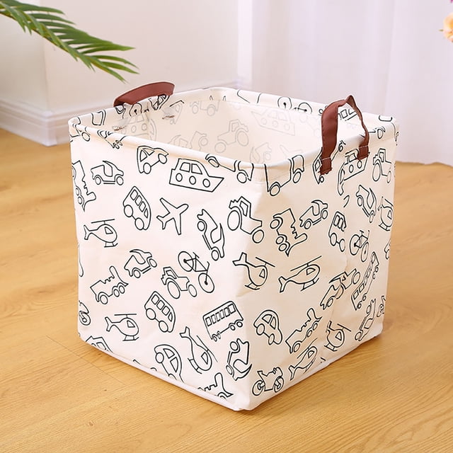 Laundry Basket Dorm Baby Laundry Basket Large Laundry Hamper with Handle for Dirty Clothes, designed for laundry room storage. Features a foldable white fabric exterior with black transportation-themed illustrations, sturdy brown handles for easy carrying, and a spacious interior for clothes, toys, or miscellaneous items. Positioned on a wooden floor in a bright room.