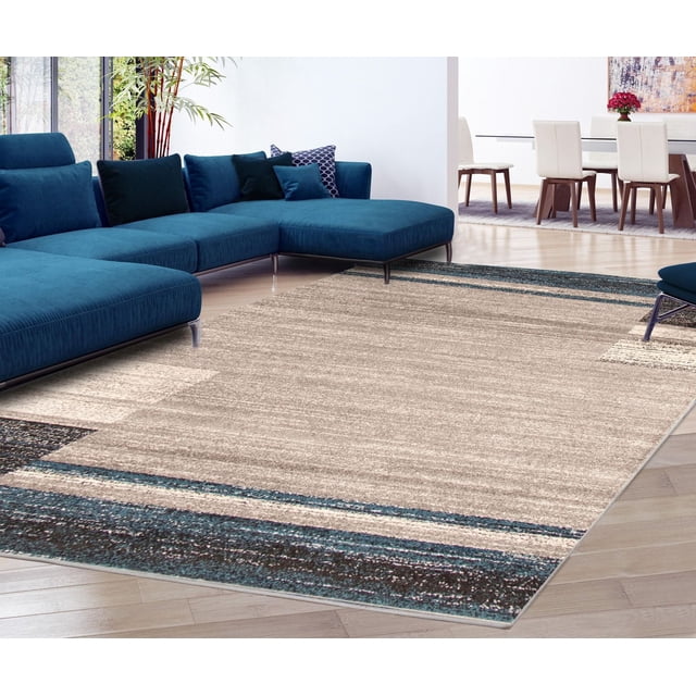soft and plush ECARPET Ayla Collection area rug with beige center and blue border placed in a contemporary living room featuring a blue sectional sofa