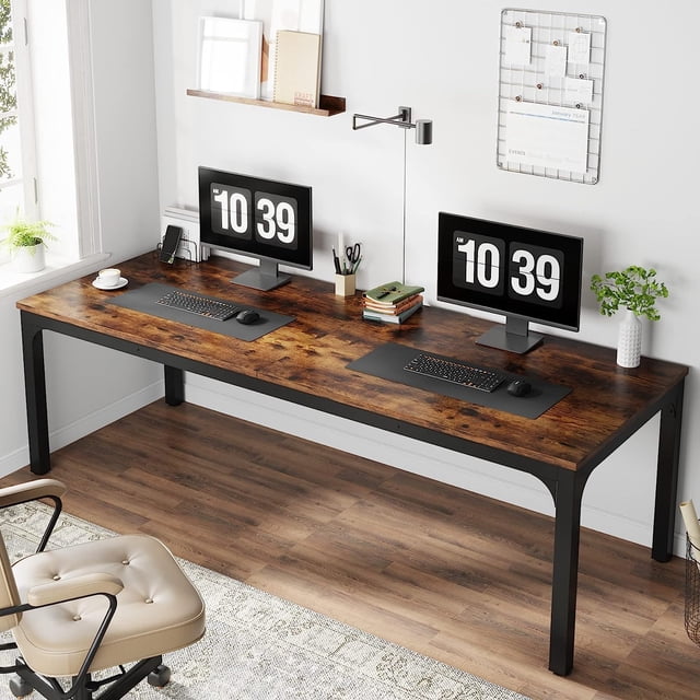 Tribesigns 78.7 Inches Extra Long Computer Desk, an industrial-style two-person workstation with a spacious 78.7-inch wide rustic wood desktop and sturdy black powder-coated iron legs. Ideal for collaborative projects or shared office spaces, the desk is shown in a modern home office setup with dual monitors, keyboards, and office supplies neatly arranged.