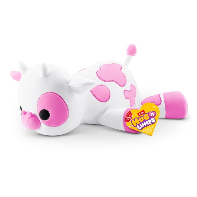 Hug A Lumps (Medium) Clover by ZURU, a cuddly weighted plush toy shaped like a white cow with pink patches, snout, ears, and tail tip, lying on its side with a heart-shaped yellow tag showing the Hug A Lumps logo, ideal for stress relief and as a collectable plush toy.