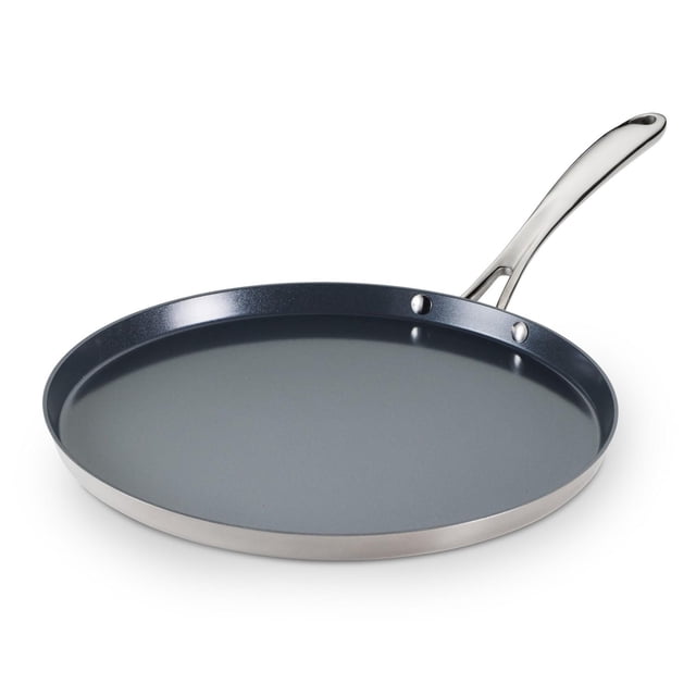 Tramontina Utsava Tri-Ply Clad Stainless Steel Ceramic Nonstick Dosa Tawa with a flat round shape, smooth grey ceramic nonstick surface, polished stainless steel tri-ply clad construction, and ergonomic stay-cool stainless steel handle, ideal for making dosas, flatbreads, and compatible with all cooktops including induction.