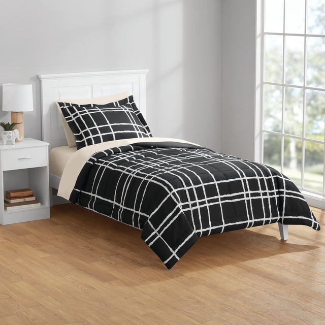 Mainstays Bed-in-a-Bag twin bedding set with black and white grid pattern comforter and pillow sham, beige fitted and flat sheets, made from OEKO-TEX certified polyester, displayed on a white wooden bed frame in a bright room with wood flooring and a white nightstand.