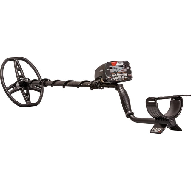Garrett AT MAX Waterproof Hand Held Metal Detector with Headphones in black, showing a side profile with elliptical search coil, adjustable stem with cable wrap, ergonomic textured handle, and digital control box with LCD screen and buttons, fully submersible to 10 feet for all-terrain metal detecting.