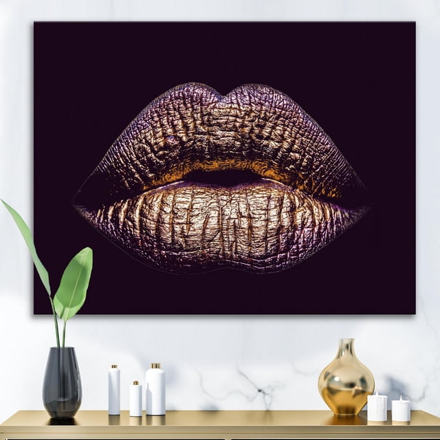 Designart Sexy Golden Metallized Female Lips III Canvas Wall Art depicting a close-up of textured golden lips with purple tones on a black background, gallery-wrapped on premium cotton canvas, ready to hang above a modern console with decorative vases and candles, suitable for contemporary home décor.