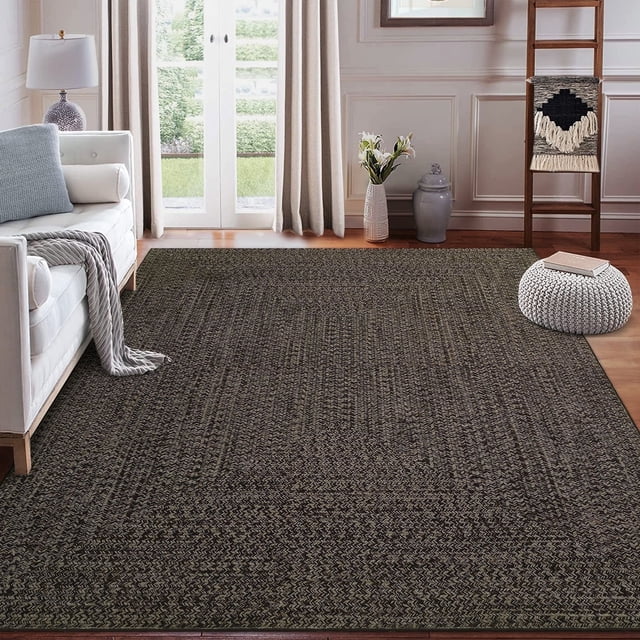 Garvee 9'x12' large area rug in brown with a braided print design, displayed in a farmhouse-style living room. The rug features a low 0.23-inch pile height, non-slip backing, and durable polyester material suitable for high-traffic indoor areas. It is machine washable and ideal for bedrooms, living rooms, dining rooms, and offices, complementing classic and elegant interior styles.