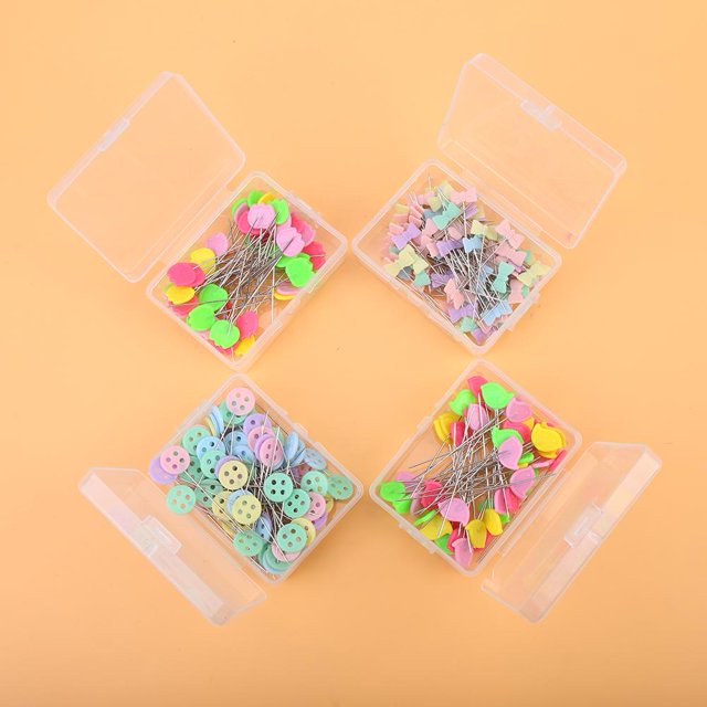 Sonew Flower Button Head Pins, 300 pcs, designed for quilting and sewing projects. These colourful pins feature decorative shapes like flowers, buttons, and butterflies, made from steel wire plated with nickel and PP plastic. Stored in four transparent plastic boxes for safe handling and organized storage, they are ideal for DIY quilting and sewing enthusiasts.