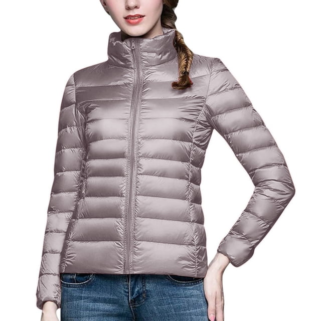 RKSTN Puffer Jacket Womens Long Sleeve Stand Collar Zip Up Winter Jacket Quilted Lightweight Down Jacket with Pockets. This women's puffer jacket features a stand collar, long sleeves, and a full zip closure. The quilted design provides lightweight warmth, while the elastic cuffs and windproof material enhance comfort in cold weather. Two side invisible zipper pockets offer practicality for storing essentials like phones or wallets. Shown in a neutral solid colour, ideal for casual wear, outdoor activities, or travel during fall, winter, or early spring.