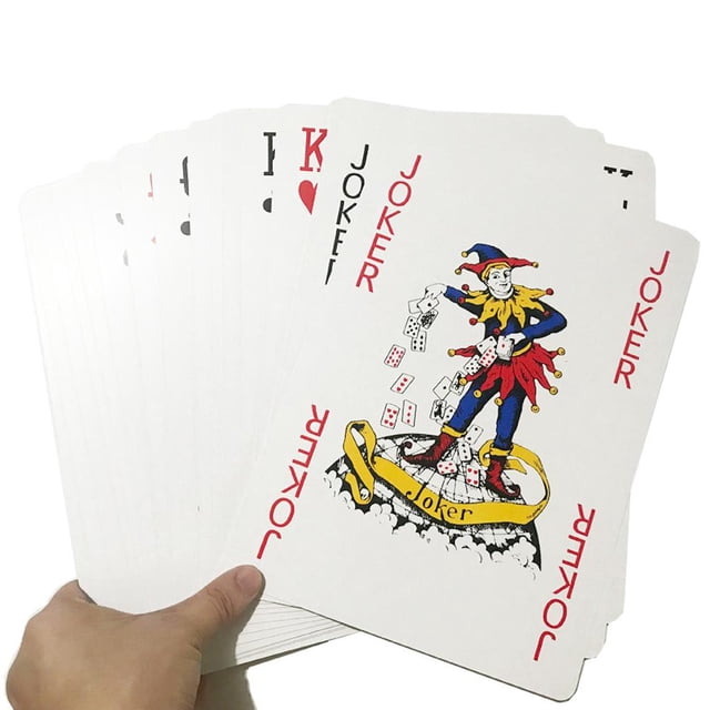 Super BigGame Theme Fantastic Poker Cards, jumbo playing cards measuring 12x17cm, held in a fan arrangement. The cards feature vibrant designs, including a Joker card with a colourful jester illustration. Ideal for table games, game room entertainment, stage performances, and decorative collectibles. Includes 54 cards made of paper.