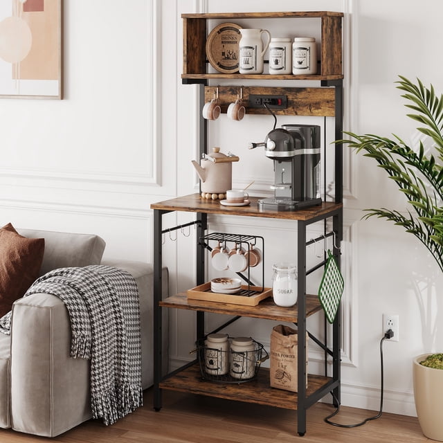 Bestier Baker’s Rack with Power Outlets, 5-Tier Kitchen Shelves with 8 Hooks, shown in rustic brown finish. The rack features a sturdy black metal frame with X-shaped sides for stability and PB particle board shelves. It includes three open shelves, a top hutch, and 8 hooks for versatile storage of kitchen essentials like jars, coffee makers, and microwaves. A built-in power outlet with three AC outlets and a switch is located in the middle section for convenient appliance use. The rack is displayed in a modern kitchen setting with various kitchen items organized on the shelves.
