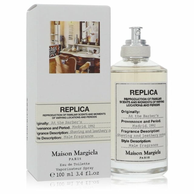 Maison Margiela Replica at the Barber's EDT for Men 100mL, a men's cologne presented in a clear glass bottle with a spray nozzle and minimalist label design, accompanied by packaging featuring a barber shop-inspired image and detailed product information.