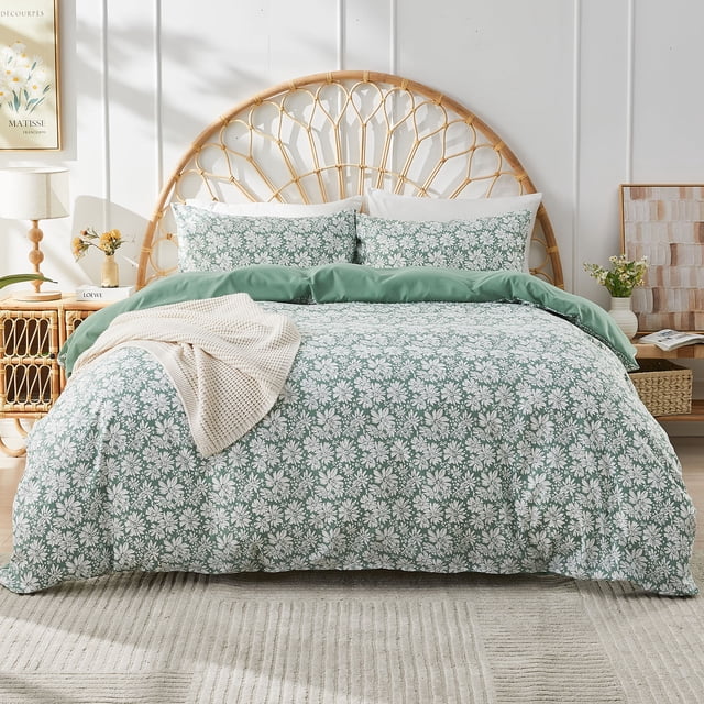 Gogreen Queen Duvet Cover Set crafted from durable, fade-resistant microfiber with a soft, breathable texture. Features a fantasy-inspired watercolor floral pattern in green and white. Includes one duvet cover and two pillowcases, displayed on a bed with a wicker headboard in a sunlit bedroom setting.