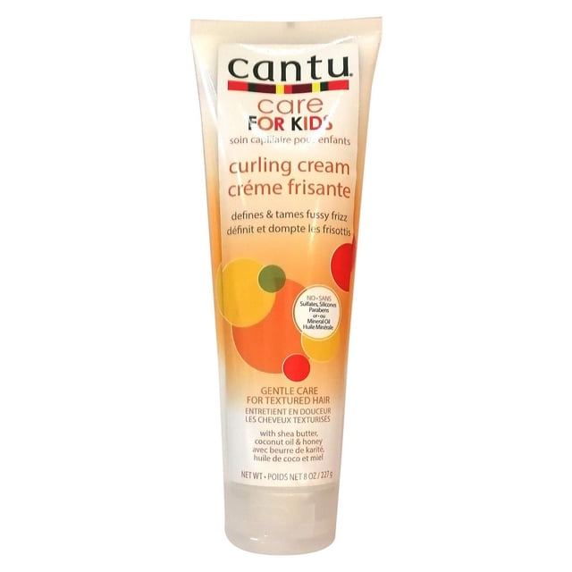 Cantu Kids Curling Cream in an 8 oz (227 g) squeezable tube with orange and yellow circular design, formulated for gentle care of textured hair, defines and tames fussy frizz, softens and strengthens strands with shea butter, coconut oil, and honey, suitable for styling and managing kids' curls.