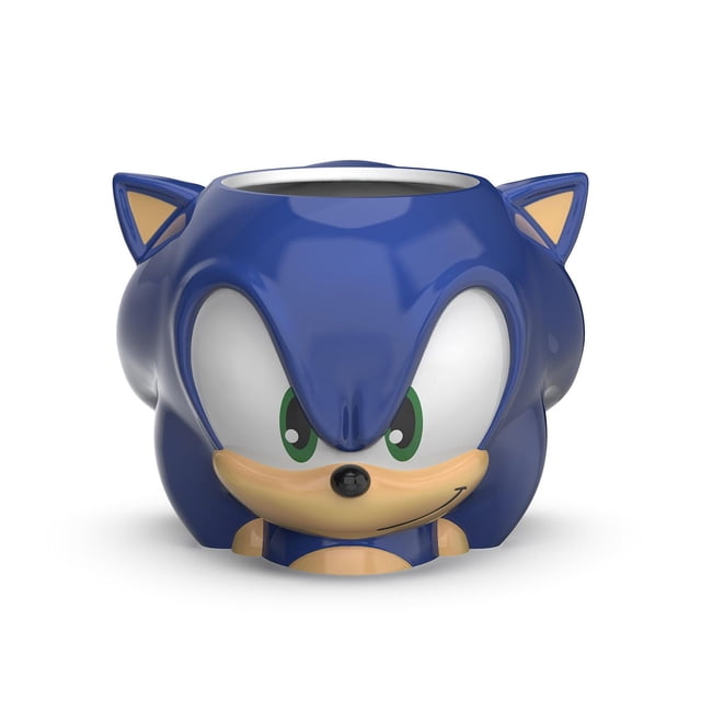 Zak Designs Sonic 15oz Sculpted Mug in blue ceramic shaped as Sonic the Hedgehog's head with green eyes, beige muzzle, and black nose, designed for hot beverages and suitable as a collectible or gift.