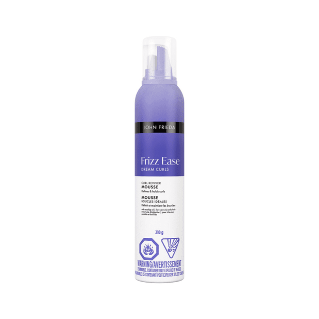 John Frieda Frizz Ease Dream Curls Curl Reviver Mousse in a purple and white 210 g bottle with clear plastic cap, designed to define and hold curls while taming frizz for natural, soft curls, suitable for colour-treated and all curly hair types.