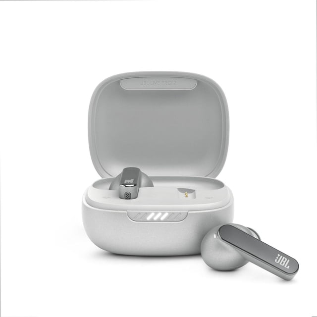 JBL Live Pro 2 TWS true wireless noise cancelling earbuds in a matte light grey charging case with one earbud inside and one outside, showing the stick closed design with oval tubes and JBL logo on the stem, featuring LED battery indicator on the case front, suitable for immersive audio and clear calls.
