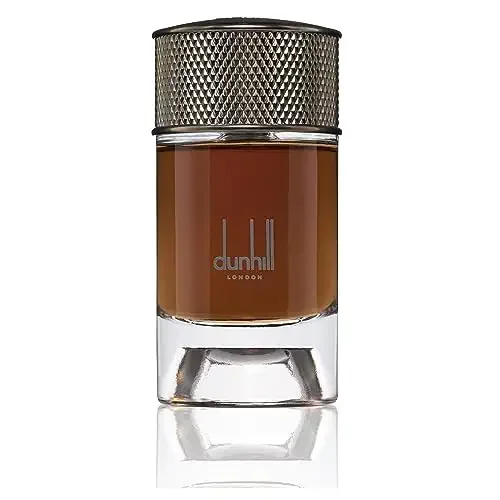 Dunhill Signature Collection Egyptian Smoke EDP 100mL perfume bottle with a sleek cylindrical design. The bottle features a transparent base showcasing the amber-hued fragrance, topped with a textured metallic cap. Suitable for women, this oriental and woody fragrance is ideal for various occasions.