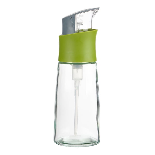 Trudeau Press & Measure Oil Glass Bottle – 10.8 oz with a clear glass body, green silicone grip, and gray press-and-measure top featuring a dripless spout for precise oil dispensing, ideal as an oil dispenser and kitchen tool, easy to clean and disassemble.