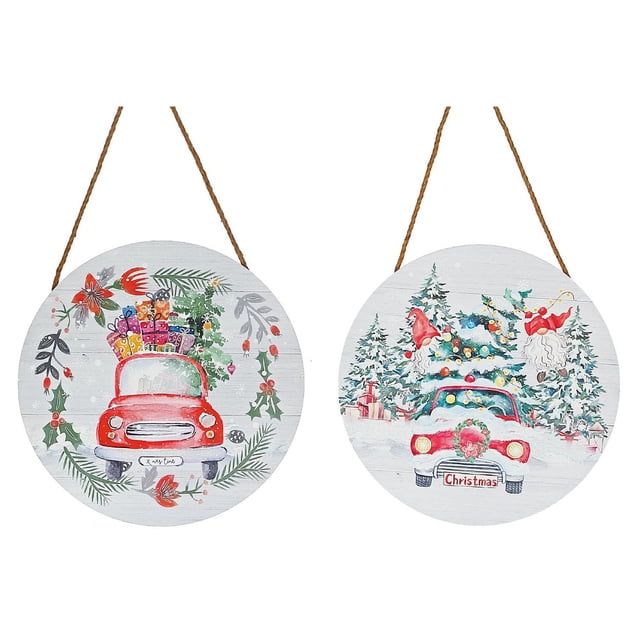 Mdf Round Wall Hanger (Holiday Red Truck) (Asstd) - Set of 2 wooden round wall hangings with Christmas red truck designs; one shows a truck carrying colorful gifts framed by festive greenery, the other features a wreath-decorated truck in a snowy pine forest with presents and holiday gnomes, each with a hanging rope, suitable for seasonal home décor.