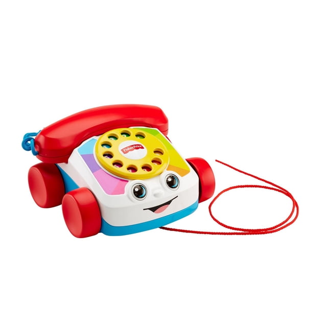 Fisher-Price Chatter Toy Telephone, a colorful educational toy with a yellow spinning dial, red receiver, and bright red wheels. The toy features a smiling face with moving eyes and a pull cord for interactive play. Designed for children aged 5-7 years, it introduces numbers 1-9, encourages fine and gross motor skill development, and stimulates sensory exploration.