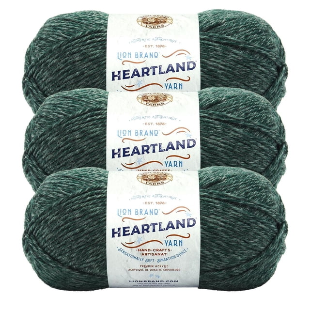 Lion Brand Yarn Heartland Yarn 3Pack with three skeins of worsted weight acrylic yarn in a heathered dark green colour, each wrapped in a white label showing the brand and product name. This machine washable yarn is ideal for knitting, crochet, and crafting projects.