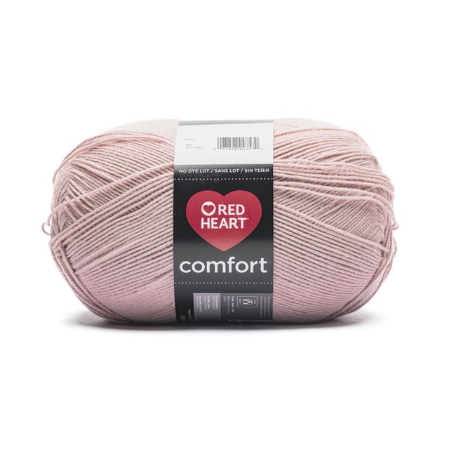 Red Heart® Comfort™ #4 Worsted (Medium) Acrylic Yarn in soft pink, 16oz/454g ball with 867 yards, tightly wound skein with black label featuring Red Heart logo and care instructions, ideal for knitting, crochet, and suitable for making blankets and throws.