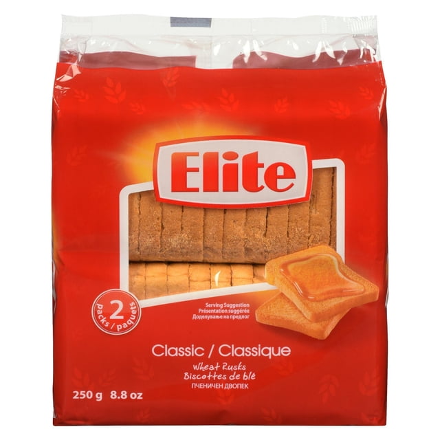 Elite Classic Wheat Rusks in a red package containing two packs, with a clear window showing sliced wheat rusks and an image of two rusks topped with honey, weighing 250 g (8.8 oz), ideal as a crunchy bread snack and suitable for shelf storage.