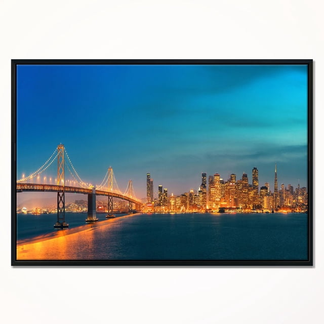 Design Art Skyline de San Francisco la Nuit Impression d'Art sur Toile Encadrée Présentant une Vue Frontale de la Skyline de San Francisco Illuminée et du Pont de la Baie au Crépuscule, Imprimée sur Toile Enveloppée de Galerie Tendue sur un sous-Cadre en Bois de 1 Po avec un Cadre Flottant en Bois Noir, Prête à Accrocher avec la Quincaillerie Incluse, Convient à la Décoration Murale et Est Souvent Utilisée pour Ajouter une Touche Urbaine Moderne aux Espaces de Vie.