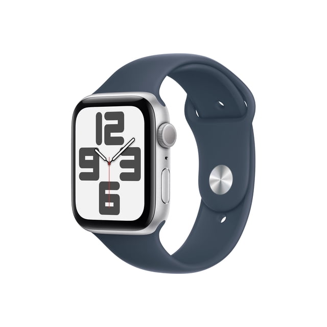 Apple Watch SE2 44mm GPS Silver Aluminum Case with Denim Sport Band S/M showing a front 3/4 view of the rectangular smartwatch with a silver aluminum case and expansive Retina display featuring large black numerals 12, 3, 6, and 9 on white, paired with a dark blue denim sport band in flexible material with a silver pin closure, ideal for activity tracking and health monitoring and suitable for casual daily wear.