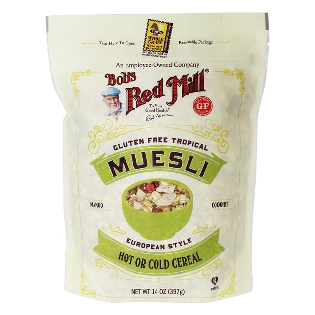 Bob's Red Mill Gluten Free Tropical Muesli, European Style, 14 oz (397 g) resealable package. The front of the bag highlights the product as a hot or cold cereal with gluten-free grains, dried fruits, nuts, and seeds. The design features a green bowl with visible cereal ingredients like mango and coconut.
