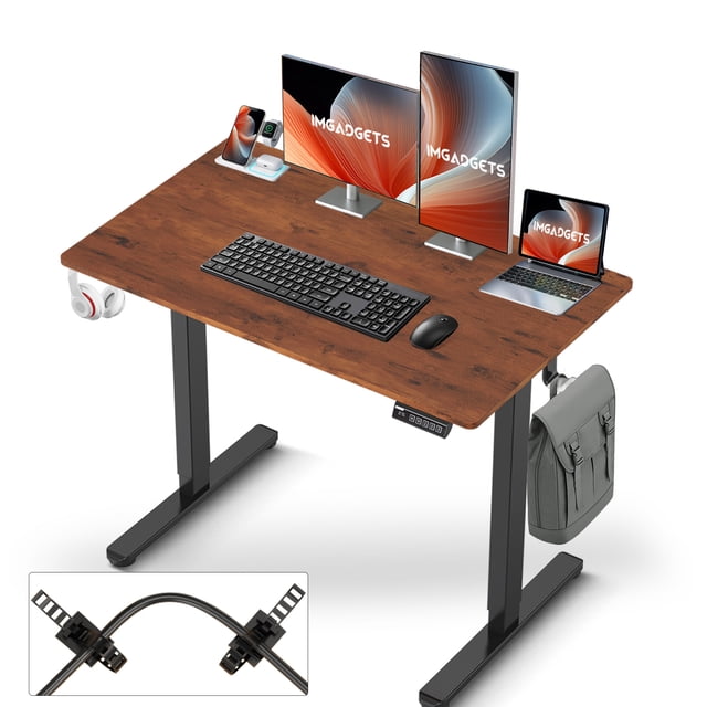 IMGadgets Standing Electric Adjustable Desk with a 40'' x 24'' large workspace, shown in a wood-patterned finish. The desk features a spacious surface accommodating two monitors, a laptop, and accessories. It includes two hooks for items like headphones and bags, and a control panel for electric height adjustments from 28'' to 47''. The desk is scratch-resistant, waterproof, and designed for ergonomic sit-stand use in home or office settings.