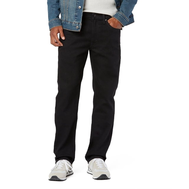 Levi Strauss Signature™ Men's Straight Fit Jeans in black with low waist, zip fly, and 5-pocket styling, shown front-facing on a model wearing a denim jacket and white sneakers. Made with Ultimate Flex denim offering 28% stretch for comfort and mobility, ideal for casual or versatile wear.