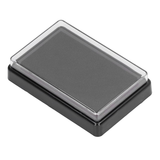 Baby Footprint Ink Pad by FLAMEEN, featuring a black ink pad encased in a compact rectangular PVC container measuring approximately 9.3 x 6.5 x 2.2cm. Ideal for creating lasting memories of baby handprints and footprints, it includes two sheets of paper for imprinting. The acid-free ink is safe for sensitive skin, easy to clean, and suitable for use with stamps and ink pads.