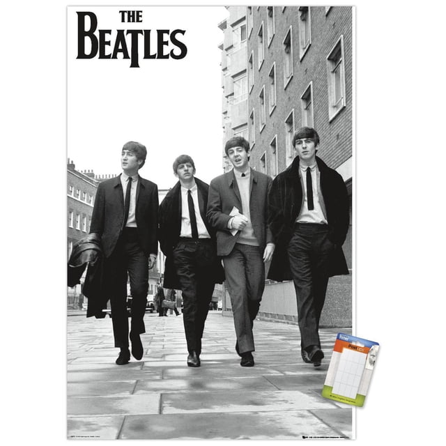 The Beatles - In London Wall Poster, 22.375" x 34" featuring a black and white photo of four men walking on a paved London street beside a brick building, dressed in suits and coats, with the band's name in bold black letters at the top left, printed on glossy poster paper suitable for home or office wall décor.