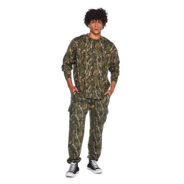 No Boundaries All Gender Oversized Long Sleeve Tee Shirt in green and brown camouflage pattern, shown with matching cargo pants and black high-top sneakers, featuring a relaxed oversized fit, ribbed collar, and long sleeves with drop shoulders, ideal for casual or layered wear.