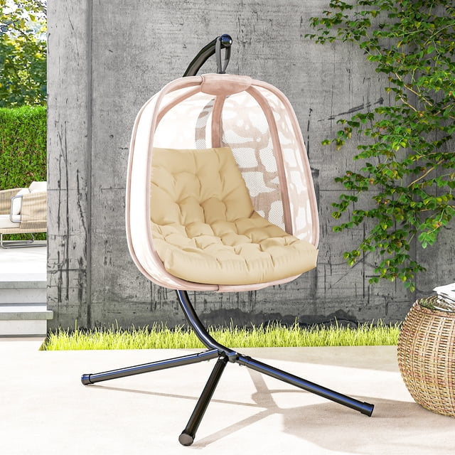 Outsunny Outdoor Swing Cushion in beige, designed for swing and egg chairs. The tufted cushion features a dual-colour polyester fabric cover that is breathable, fade-resistant, and smooth to the touch. It includes thick PP cotton filling for enhanced comfort and a tufted design to prevent shifting. The cushion measures 47.2 inches long, 39.4 inches wide, and 3.1 inches thick, suitable for both indoor and outdoor use. Displayed on a hanging egg chair in a modern patio setting with greenery and a concrete wall in the background.