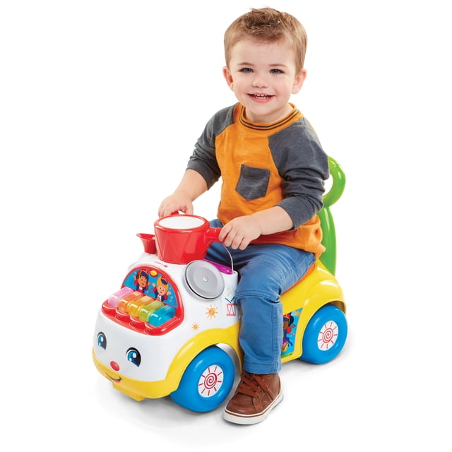 Little People Music Parade Ride-On for Ages 1-3 front-facing ride-on with push handle and extra-wide wheels, light-up keyboard with five marching tunes, drum and cymbal sounds, ignition/rev button and lights, under-seat storage with included toy trumpet; 44 lb (20 kg) capacity; suitable for early push-walking and cause-and-effect play.