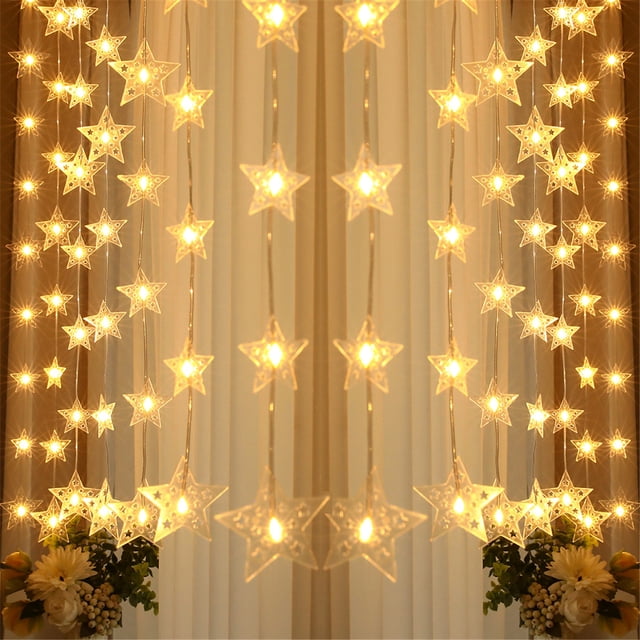 EGNMCR Pentagram Curtain Lights, USB-powered LED pentagram string lights with warm white illumination. The cascading curtain design features star-shaped lights, perfect for creating a festive atmosphere. Includes a remote control with eight light modes, suitable for indoor decoration such as bedrooms, parties, weddings, and Christmas celebrations. Displayed against a neutral background with floral accents.